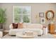 Bright living room with modern decor, plush seating, and a large window at 3881 Zenobia St, Denver, CO 80212