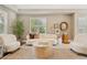 Cozy living room featuring plush seating, stylish decor, and hardwood floors at 3881 Zenobia St, Denver, CO 80212