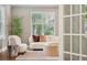 Bright living room featuring plush seating, a round coffee table, and a large window at 3881 Zenobia St, Denver, CO 80212