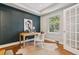 Stylish home office with wood floors, a chic desk, and a large window for natural light at 3881 Zenobia St, Denver, CO 80212
