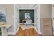 Elegant home office featuring dark accent wall, stylish decor, and beautiful hardwood flooring at 3881 Zenobia St, Denver, CO 80212