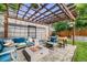 Outdoor pergola area complete with furniture, a fire pit, string lights and landscaped backyard at 3881 Zenobia St, Denver, CO 80212