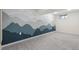 Spacious room featuring an accent wall with a monochromatic mountain range mural and neutral carpeting at 3881 Zenobia St, Denver, CO 80212