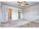 This bedroom includes an ensuite bathroom, a ceiling fan, and a walk-in closet at 7260 S Gaylord St # E26, Littleton, CO 80122