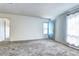 Bright bedroom with neutral carpet and white walls with door to outside at 7260 S Gaylord St # E26, Littleton, CO 80122