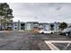 View of complex featuring ample parking and a blue exterior at 7260 S Gaylord St # E26, Littleton, CO 80122
