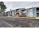 Apartment complex shows modern architecture with a parking lot in front at 7260 S Gaylord St # E26, Littleton, CO 80122