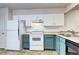 Bright kitchen with white cabinets, stainless steel appliances, and custom backsplash at 7260 S Gaylord St # E26, Littleton, CO 80122