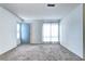 Bright living room with neutral carpet and a large window at 7260 S Gaylord St # E26, Littleton, CO 80122