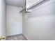 This is an empty walk-in closet with neutral carpet and one rack at 7260 S Gaylord St # E26, Littleton, CO 80122