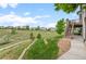 Expansive backyard featuring lush greenery, a retaining wall, and a staircase leading to a deck at 3041 Starling Ct, Castle Rock, CO 80109