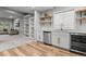 Stylish wet bar area with white cabinets, butcher block shelves, wine cooler, and stainless steel appliances at 3041 Starling Ct, Castle Rock, CO 80109