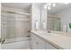 Cozy bathroom featuring a shower-tub, white cabinets and tile, and chrome fixtures at 3041 Starling Ct, Castle Rock, CO 80109