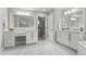 Elegant bathroom featuring dual sinks, granite countertops, and decorative mirrors at 3041 Starling Ct, Castle Rock, CO 80109