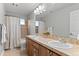 Charming bathroom with dual sinks, mosaic tile accents, and a shower-tub combination at 3041 Starling Ct, Castle Rock, CO 80109