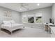 Well-lit bedroom with ceiling fan, a large window view, and a white metal frame bed with a side desk at 3041 Starling Ct, Castle Rock, CO 80109