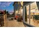 Relaxing outdoor deck with wicker furniture, stone detailing, and sliding glass doors leading inside at 3041 Starling Ct, Castle Rock, CO 80109