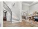 Elegant foyer showcases a curved staircase and flows into the dining and living areas at 3041 Starling Ct, Castle Rock, CO 80109