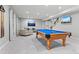 Large game room with a pool table, sectional sofa, and stairs to the upper level of the home at 3041 Starling Ct, Castle Rock, CO 80109