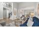 Open-concept living area with hardwood floors, large windows, and staircase leading to the second floor at 3041 Starling Ct, Castle Rock, CO 80109