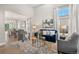 Bright living room with a large window, blue couch, and a marble rug adjoining a formal dining area at 3041 Starling Ct, Castle Rock, CO 80109