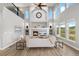Bright, modern living room with fireplace, television, and high ceilings with views of the lush lawns outside at 3041 Starling Ct, Castle Rock, CO 80109