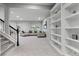 Bright and airy living room features a large sectional, built-in bookshelves, and natural light from the windows at 3041 Starling Ct, Castle Rock, CO 80109