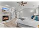 Spacious main bedroom boasts a cozy fireplace, TV, and a convenient doorway to additional storage at 3041 Starling Ct, Castle Rock, CO 80109