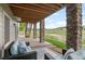Inviting covered patio with comfortable seating and stone columns, perfect for outdoor relaxation at 3041 Starling Ct, Castle Rock, CO 80109
