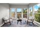 Sun-drenched sitting room has oversized windows with beautiful views and comfortable seating at 3041 Starling Ct, Castle Rock, CO 80109