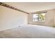 Neutral bedroom with a window and a patterned wallpaper border at 2561 Cactus Bluff Pl, Highlands Ranch, CO 80129