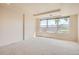 Bright bedroom with large window and neutral carpet at 2561 Cactus Bluff Pl, Highlands Ranch, CO 80129