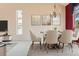 Cozy dining area with modern table set, chandelier, and natural light at 2561 Cactus Bluff Pl, Highlands Ranch, CO 80129