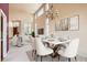 Bright dining area featuring a marble table, decorative chandelier, and large windows at 2561 Cactus Bluff Pl, Highlands Ranch, CO 80129