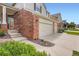 This is a two-story residence with a brick facade, attached two-car garage and inviting front entrance at 2561 Cactus Bluff Pl, Highlands Ranch, CO 80129