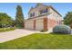 Two-story home with a well-manicured lawn and two-car garage, showcasing its inviting curb appeal at 2561 Cactus Bluff Pl, Highlands Ranch, CO 80129