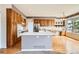 Bright kitchen featuring wood cabinets, a large island, and stainless steel appliances, perfect for cooking at 2561 Cactus Bluff Pl, Highlands Ranch, CO 80129