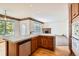 Bright kitchen featuring light wood cabinetry, tile countertops, and breakfast bar at 2561 Cactus Bluff Pl, Highlands Ranch, CO 80129