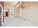 Spacious living room boasting tall ceilings, large windows, and a grand chandelier for elegant lighting at 2561 Cactus Bluff Pl, Highlands Ranch, CO 80129