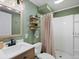 Charming bathroom with a shower, sink, and decorative wall shelves, creating a cozy atmosphere at 8915 W Quarto Pl, Littleton, CO 80128