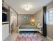 Comfortable bedroom with a cozy bed, built-in desk, and soft lighting for a relaxing ambiance at 8915 W Quarto Pl, Littleton, CO 80128