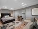 Spacious bedroom featuring a plush bed, a comfortable seating area, and a large mirror at 8915 W Quarto Pl, Littleton, CO 80128