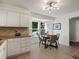 Eat-in kitchen area with large windows, a dining table and updated lighting at 8915 W Quarto Pl, Littleton, CO 80128