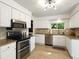 Well-lit kitchen featuring stainless steel appliances, granite counters and white cabinets at 8915 W Quarto Pl, Littleton, CO 80128