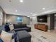 Inviting living room with a large sectional sofa, entertainment center, and plenty of natural light at 8915 W Quarto Pl, Littleton, CO 80128