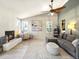 Inviting living room featuring a fireplace, stylish decor, and plenty of natural light at 8915 W Quarto Pl, Littleton, CO 80128