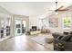 Open living room with fireplace, vaulted ceilings, natural light and access to the outdoor deck at 8915 W Quarto Pl, Littleton, CO 80128