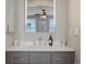 Updated main bathroom featuring a mirror, vanity and modern fixtures at 8915 W Quarto Pl, Littleton, CO 80128