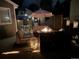 Well-lit outdoor patio with comfortable seating, fire pit, and stylish lanterns for serene evenings at 8915 W Quarto Pl, Littleton, CO 80128