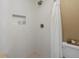 Elegant shower features textured walls, recessed shelf, and modern fixtures at 8915 W Quarto Pl, Littleton, CO 80128